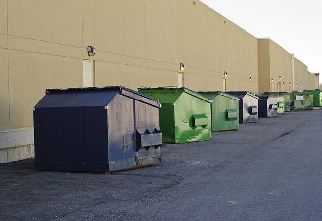 portable, green construction dumpsters serving as a container for scrap materials in Audubon